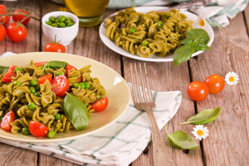 Fusilli pasta with cherry tomatoes and peas.