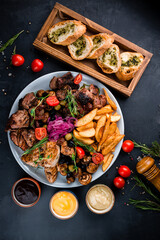 Big portion beef and chicken barbecue with potato wedges, marinated red onion, fried mushrooms, garlic bread and sauces.