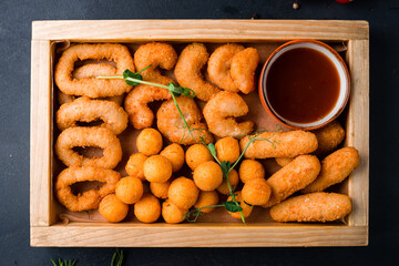 Dinner fried nuggets, onion rings, breaded mozzarella cheese balls and shrimp and sauces. - 568499636