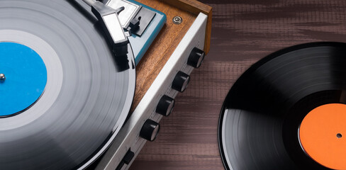there are records and a vinyl record player on a wooden table