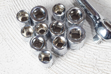 top view of different nozzle wrenches on concrete background with copy space