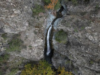 Incredible view of the Millomeris Waterfall among the fascinating forest. The view from the drone. Amazing view in Cyprus.
