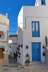 Fototapeta na wymiar Street and houses of famous white spanish village Competa, Andalusia, Spain