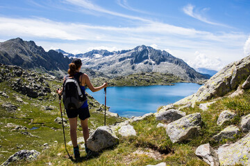 Young hiker girl summit to Montardo Peak in AIguestortes and Sant Maurici National Park, Spain