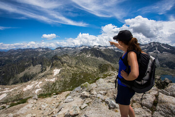 Young hiker girl summit to Montardo Peak in AIguestortes and Sant Maurici National Park, Spain