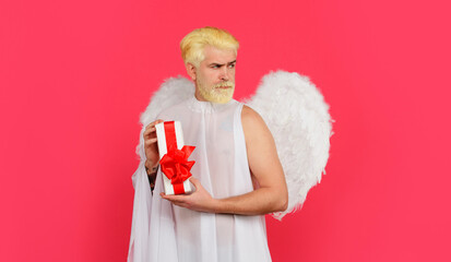 Happy Valentines Day. Cupid with present box. Serious man in angel costume with gift. February 14.