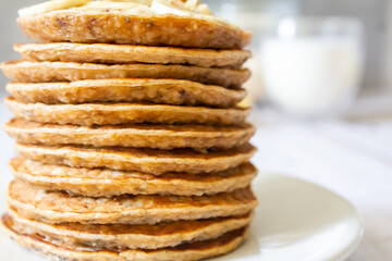 A stack of oatmeal pancakes on white plate. Healthy breakfast for the whole family, copy space, selective focus.