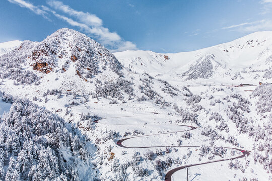 Vallter 2000 ski resort. Aerial winter landscape with a very winding road. Setcases, Ripoll&eacute;s, Girona Pyrenees, Catalonia. Vacations, travel, nature and tourism concept.