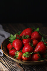 A bowl with ripe bright strawberry in rustic style	