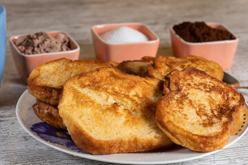 (Torrijas) Fried bread soaked in milk flavored with vanilla, cinnamon and lemon, and egg. Typical Easter sweet. Traditional and festive cuisine concept.