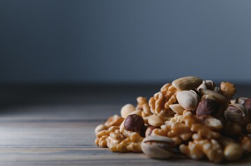 mixed nuts in a bowl on wooden table, top view with copy space.