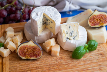 delicious blue brie blue cheese with grapes  on a wooden board