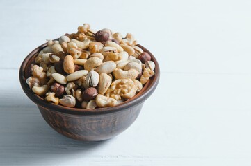 Naklejka na ściany i meble Mixed nuts on a plate. White background