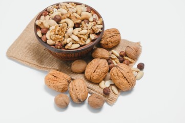 Mixed nuts on a plate. White background