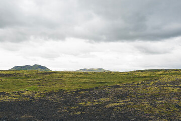 Vast land covered with gravel and moss in Iceland on cloudy day