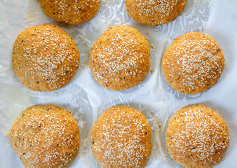 Top view of fresh baked keto buns, Low carb buns baked with psyllium husk and flax seeds. Ketogenic diet and gluten free bread. Fresh baked keto bread for healthy eating concept.