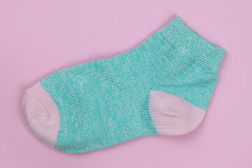 Baby sock on a pink background