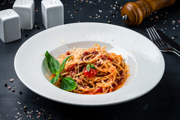 Lunch pasta with tomatoes, cheese, tomato sauce and basil.