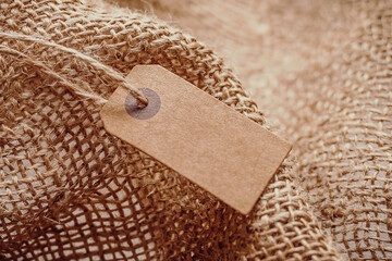 Craft tag with a lace on the background of burlap