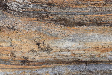 Gold brown and grey stone patterns with stripes from riverbed of Vale Verzasca in Switzerland