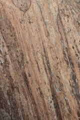 Gold brown and grey stone patterns with stripes from riverbed of Vale Verzasca in Switzerland