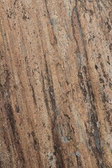 Gold brown and grey stone patterns with stripes from riverbed of Vale Verzasca in Switzerland