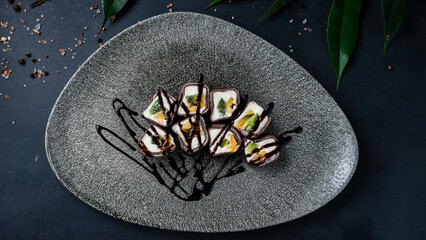 Set of maki sushi rolls with chocolate pancakes, sweet cream cheese, kiwi and mango. © smspsy