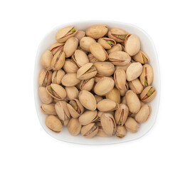 White bowl of pistachios nuts isolated on a white background top view