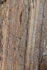 Gold brown and grey stone patterns with stripes from riverbed of Vale Verzasca in Switzerland