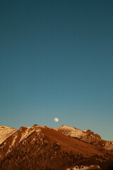 Mountain Peak at Sunset with Full Moon in Val di Susa