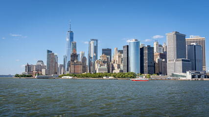 Battery Park, Freedom tower and lower Manhattan panorama from a ferry on the Hudson river on a summer day