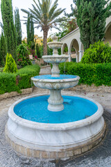 Picturesque refreshing fountain in the spring garden.