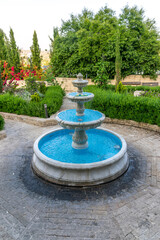 Picturesque refreshing fountain in the spring garden.
