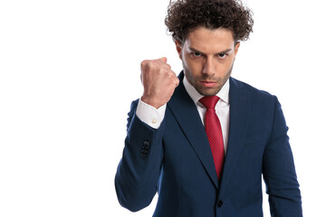upset young bussinessman showing fist and threatening