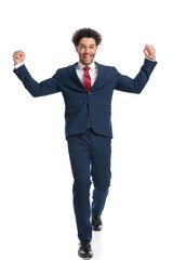 excited young businessman with curly hair celebrating victory