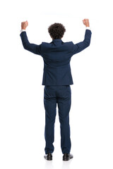 excited young businessman holding fists in the air and celebrating