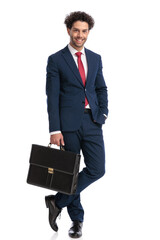 full body picture of elegant businessman with hand in pocket smiling