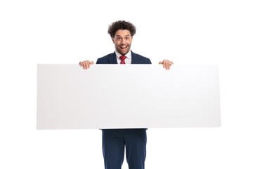 excited young businessman presenting white empty board and smiling