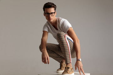 casual man posing with attitude and wearing glasses