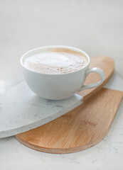 One large white cup of delicious fragrant cappuccino or latte coffee