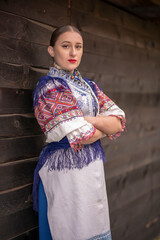 Fototapeta na wymiar Young beautiful slovak woman in traditional dress. Slovak folklore