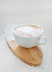 One large white cup of delicious fragrant cappuccino or latte coffee