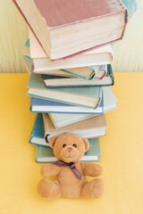 Teddy bear and high stack of books