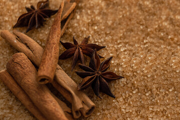 Spices for baking. Cinnamon sticks and star anise lie on cane sugar