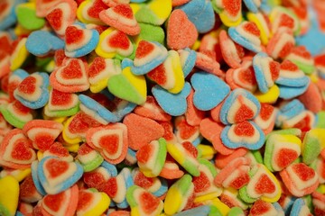 delicious, jelly, multi-colored sweets, lie on the table. a lot of colored, sweet candies, a background of many green, blue, yellow, pink, cyan, white, black, red candies of various shapes