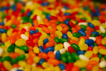 delicious, jelly, multi-colored sweets, lie on the table. a lot of colored, sweet candies, a background of many green, blue, yellow, pink, cyan, white, black, red candies of various shapes