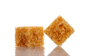 Two cubes of brown sugar, close-up, isolated on white.