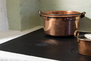 Vintage copper pans stand on stove
