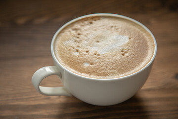 One large white cup of delicious fragrant cappuccino or latte coffee