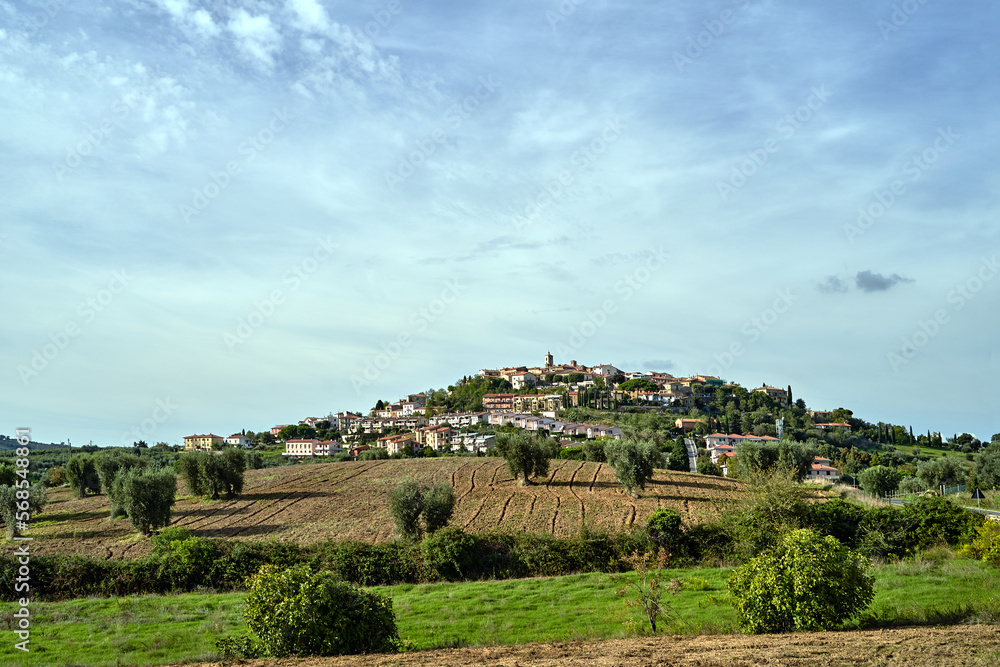 Poster tower of a stone medieval church in the village of montiano in tuscany